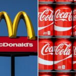 Composition of the McDonald's logo and a stack of Coca-Cola cans