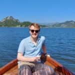 Reporter Craig Munro on a boat in Lake Skadar, Montenegro