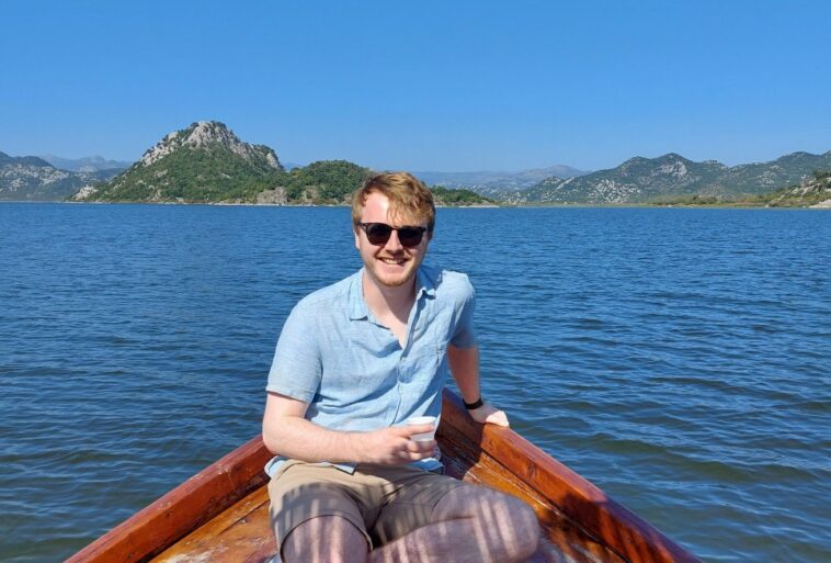 Reporter Craig Munro on a boat in Lake Skadar, Montenegro