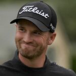 Wyndham Clark smiles while walking to the 18th green at Pebble Beach Golf Links during the third round of the AT&T Pebble Beach National Pro-Am golf tournament in Pebble Beach, Calif., Saturday, Feb. 3, 2024. (AP Photo/Ryan Sun)