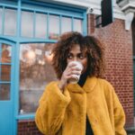 Portrait of a young adult beautiful woman drinking coffee