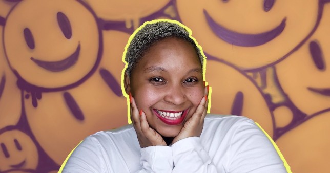 Nobuhle with her face in her hands, in front of a background of graffiti smiley faces