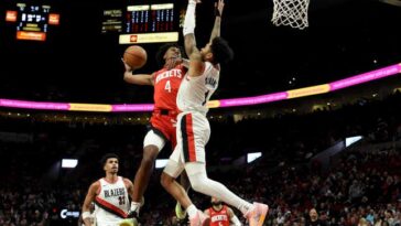 Houston Rockets guard Jalen Green (4) goes up for a dunk against Portland Trail Blazers guard Anfernee Simons, right, during the second half of an NBA basketball game in Portland, Ore., Friday, March 8, 2024. 
