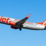 Low Cost airline Jet2 in the air. Boeing 737-700 departing into blue sky.