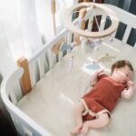 Cute baby girl in her crib