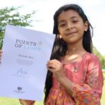 Dr Ragini G Roy's daughter, Moksha, holding a certificate