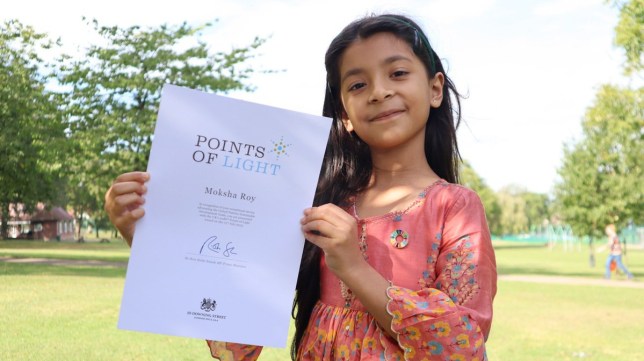 Dr Ragini G Roy's daughter, Moksha, holding a certificate