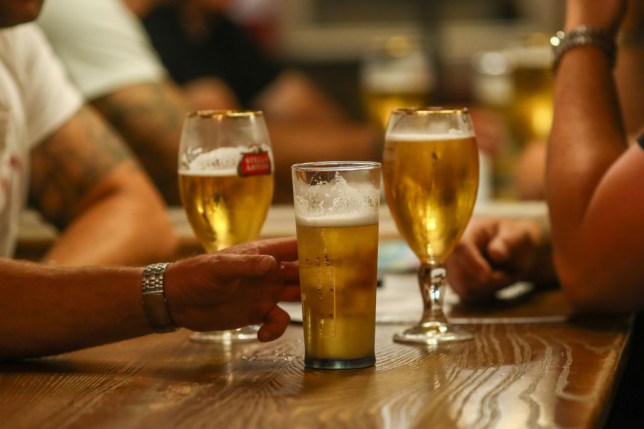 Customers drinking beer at The Moon Under Water pub in London