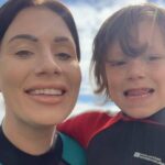 Billie Smith and her son in wetsuits.