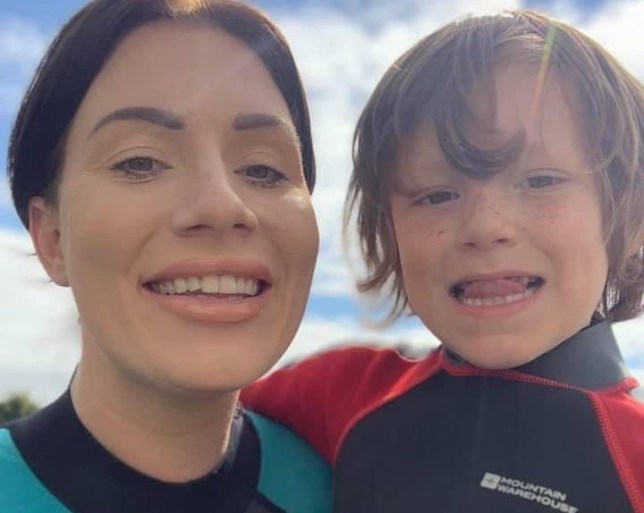 Billie Smith and her son in wetsuits.