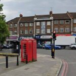 A telephone box on a busy road