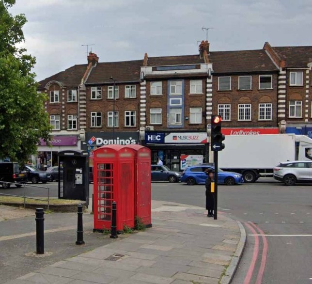 A telephone box on a busy road