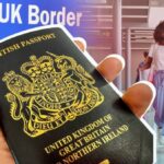 Passport being held in front of picture of people at the airport