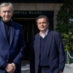 Bernard Arnault and Jean-Michel Othoniel pose in front of the Cheval Blanc Paris hotel.