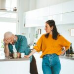 Serious woman arguing with man in kitchen at home