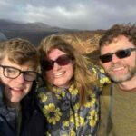 Mark on a windy cliffside with his late partner Cecilia and son