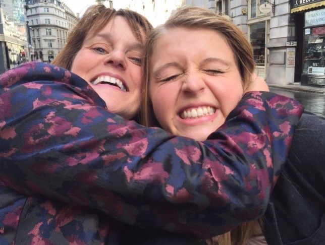 Marie Devereux cuddling daughter Natalie in the street