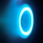 The glowing blue ring of an electric Hall thruster. in an otherwise black image.