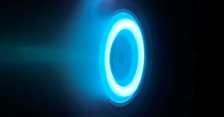 The glowing blue ring of an electric Hall thruster. in an otherwise black image.