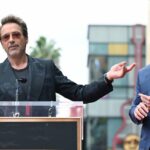 Mark Ruffalo and Chris Hemsworth dressed in black, posing together on the red carpet at the "Thor: Ragnarok" premiere