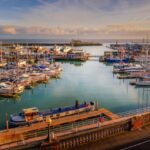 The impressive entrance to the historic Royal Harbour of Ramsgate, Kent, Uk, full of leisure and fishing boats of all sizes and a grey border force boat