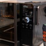 A black indoor smoker on a white countertop.