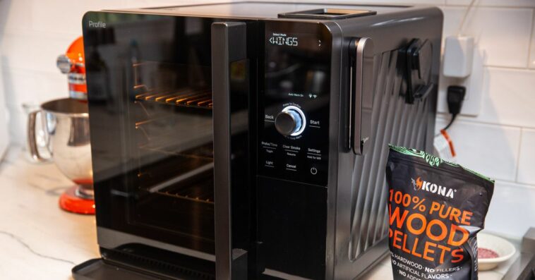 A black indoor smoker on a white countertop.