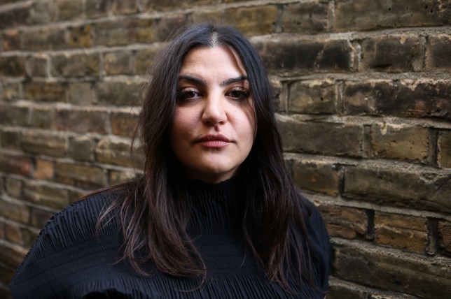 Almara Abgarian standing in front of a brick wall (head and shoulders only)