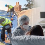 Image of roofers next to midwives assisting labour