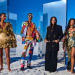 Designer Olivier Rousteing poses with models in the Disney x Balmain: The Lion King collection.