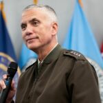 A photo of General Paul Nakasone with a microphone in hand.