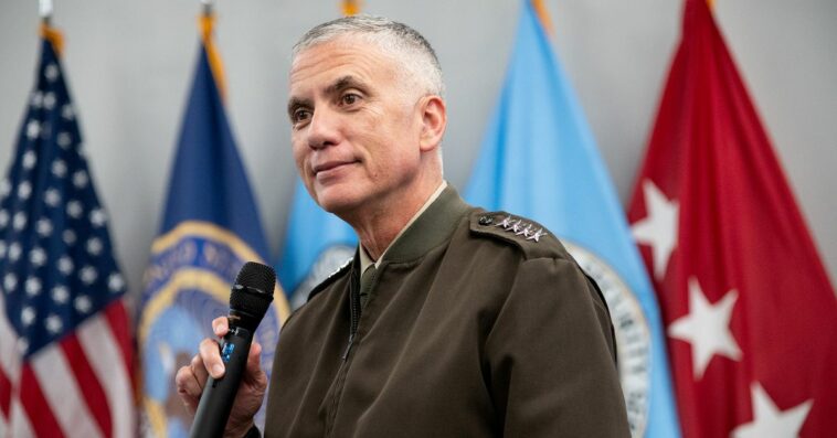 A photo of General Paul Nakasone with a microphone in hand.