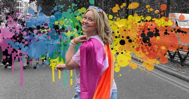 Sarah Brazel-Terris at Pride, wearing a Pride flag, with the Pride colours in the background