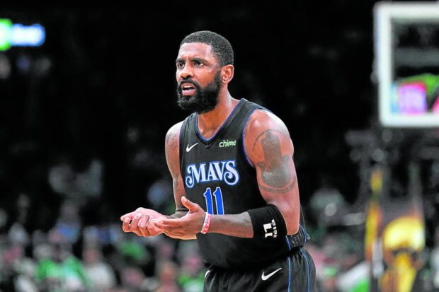 Dallas Mavericks guard Kyrie Irving (11) reacts in the third quarter against the Boston Celtics during game one of the 2024 NBA Finals at TD Garden. Mandatory Credit: David Butler II-USA TODAY Sports