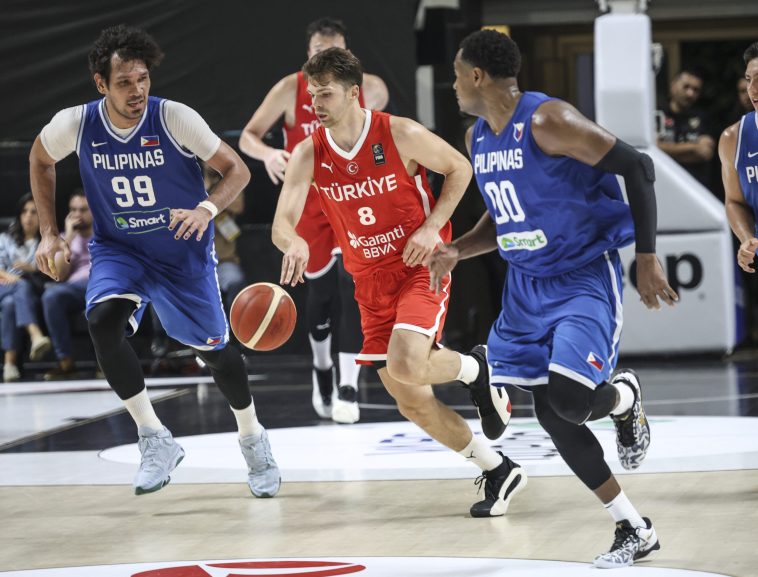 Gilas Pilipinas' June Mar Fajardo and Justin Brownlee flank as Turkey player during a tune-up game in Istanbul ahead of the Fiba OQT.