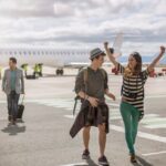 People walking across tarmac at an airport