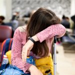 Woman with her suitcase in the airport lounge