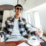 Business people flying in private jet. SuccessfulChinese fin-tech entrepreneur enjoying flight in private jet