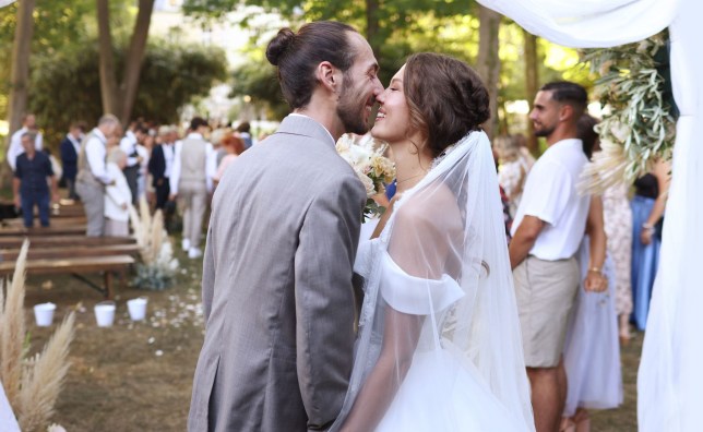 A newlywed couple embracing during their wedding ceremony