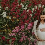 Ruth in a white dress against flowers