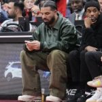 TORONTO, ON - NOVEMBER 6: Drake uses his phone as him and Future the Prince watch the game between the Toronto Raptors and the Chicago Bulls at the Scotiabank Arena on November 6, 2022 in Toronto, Ontario, Canada. NOTE TO USER: User expressly acknowledges and agrees that, by downloading and/or using this Photograph, user is consenting to the terms and conditions of the Getty Images License Agreement. (Photo by Mark Blinch/Getty Images)