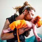 Father Kissing His Baby Boy Wearing Lion Cub Costume