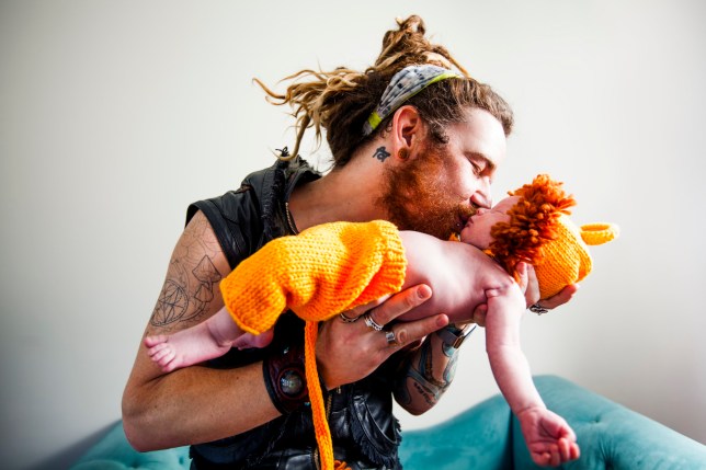 Father Kissing His Baby Boy Wearing Lion Cub Costume