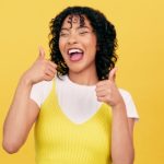 Excited, thumbs up and portrait of woman.