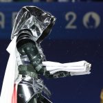 A woman carrying the Olympic flag is seen at the Trocadero during the Opening Ceremony of the Olympic Games Paris 2024