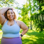 Young woman taking a break fromexercising outdoors