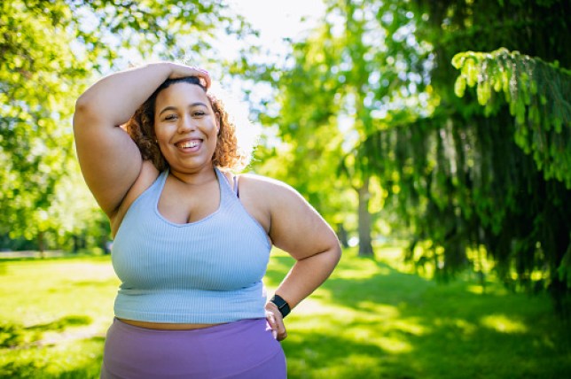 Young woman taking a break fromexercising outdoors