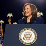 U.S. Vice President Kamala Harris gives a speech, standing behind a plinth that has the 'vice president of the united states' on it