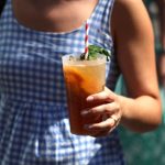 A woman holding a cup of Pimm's