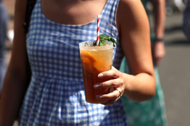 A woman holding a cup of Pimm's